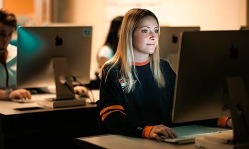 female student designing on a computer