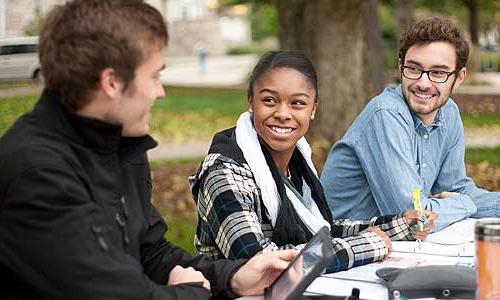 three Carroll University students working outside.